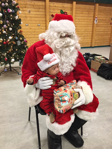 Santa visiting the children at the Cambridge Bay Community Hall